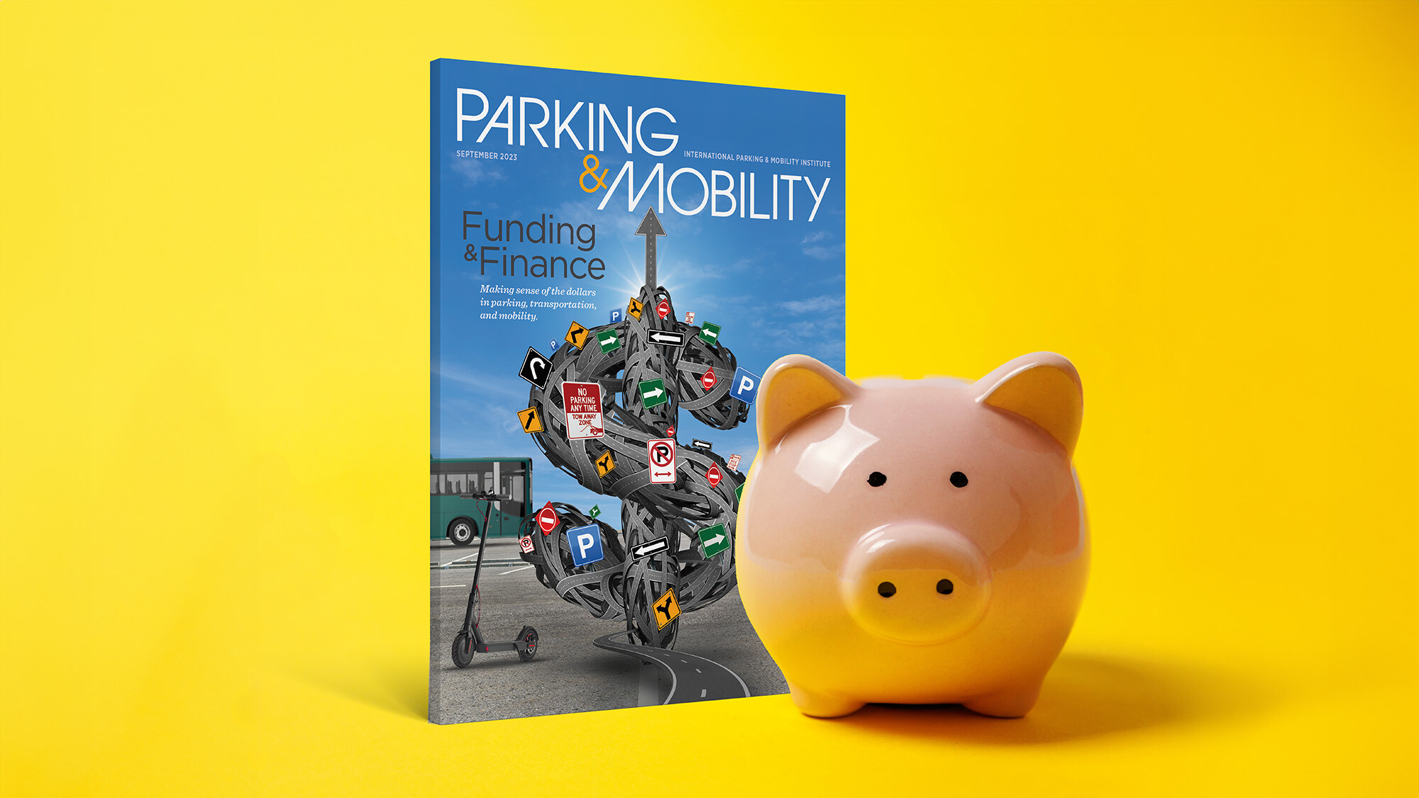 Yellow backdrop with a photo of a piggy bank and a Parking & Mobility magazine standing up behind it.